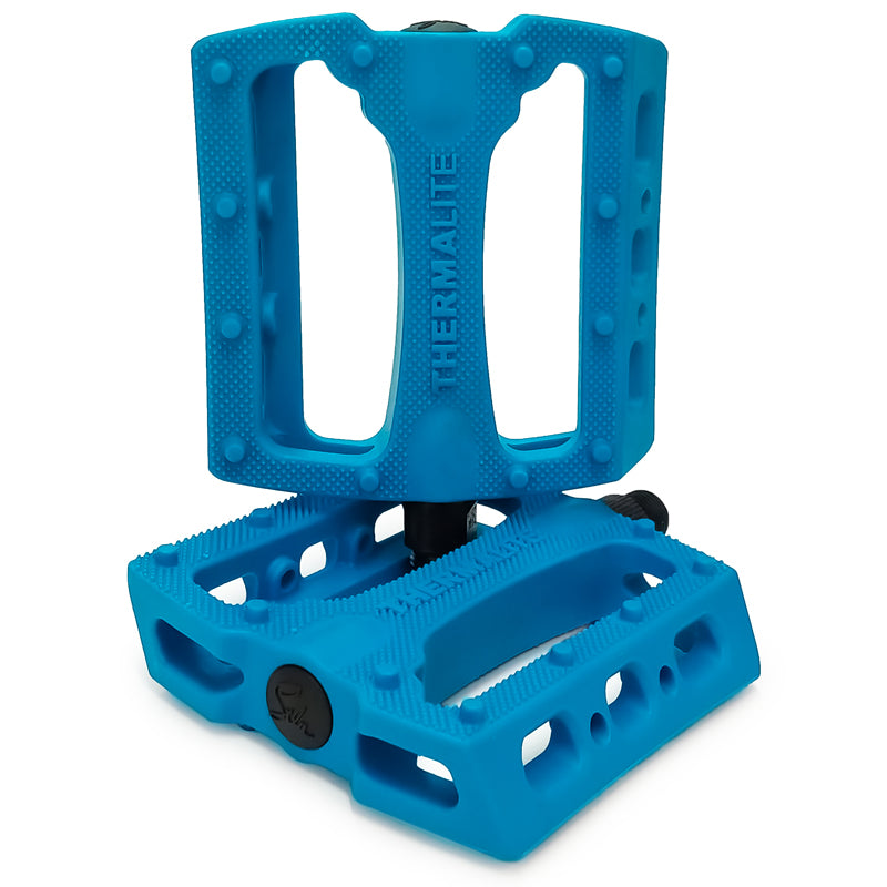 Colorful tie-dye STLNbikes Thermalite Platform Pedals for bikes, featuring a durable platform design with textured grip.