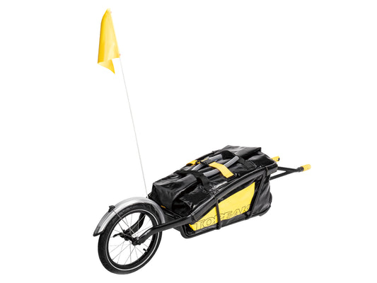 Topeak Journey TX Thru-Axle Trailer attached to a bicycle, showcasing a durable bike trailer for transporting gear.