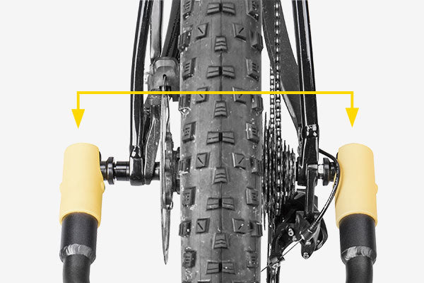 Topeak Journey TX Thru-Axle Trailer attached to a bike, showing its compact design and secure hitch for bike transport.