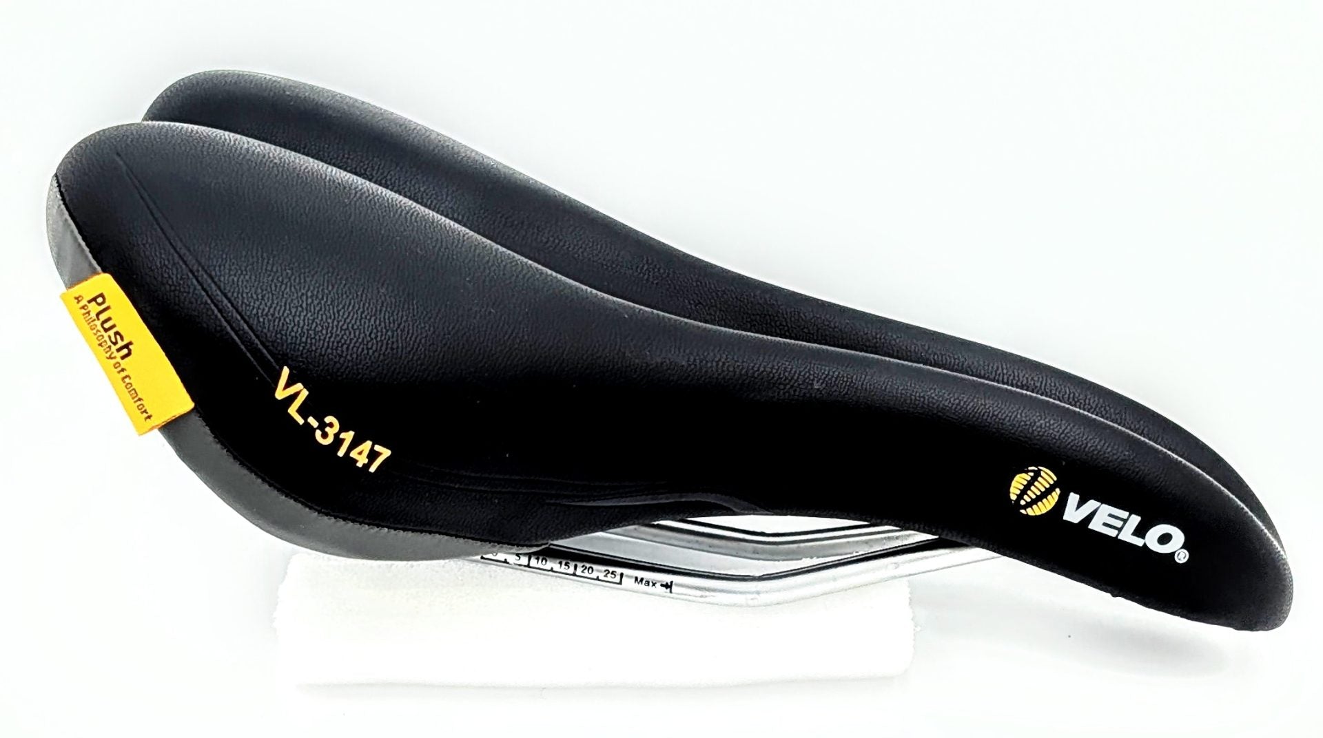 Velo Plush Saddle showing its wide, cushioned design with a durable cover and dimensions 278mm by 150mm for comfortable cycling.
